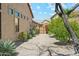 Side yard view showcasing desert landscaping and a secure gate enhancing the home's curb appeal at 7915 E Stonecliff Cir, Mesa, AZ 85207