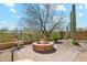 Inviting outdoor space with a cozy stone fire pit and seating area, perfect for relaxation and entertaining at 7915 E Stonecliff Cir, Mesa, AZ 85207