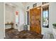 Bright foyer showcasing a beautiful wooden front door, tile flooring, and neutral decor at 7915 E Stonecliff Cir, Mesa, AZ 85207