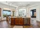 Kitchen island with granite countertops and seating with view of dining area and living space at 7915 E Stonecliff Cir, Mesa, AZ 85207