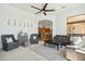 Open-concept living room with a ceiling fan, neutral colors, and seamless flow to the kitchen at 7915 E Stonecliff Cir, Mesa, AZ 85207