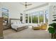 Sun-filled primary bedroom boasts large windows, neutral tones, and a relaxing sitting area at 7915 E Stonecliff Cir, Mesa, AZ 85207
