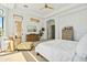 Spacious bedroom with white walls, natural wood furniture, and adjoining sitting area at 7915 E Stonecliff Cir, Mesa, AZ 85207