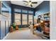 Stylish home office with built-in shelves, wood accents, and ample natural light at 7915 E Stonecliff Cir, Mesa, AZ 85207