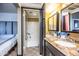 Double vanity with granite countertops, and adjoining walk-in shower and bedroom access at 8155 E Roosevelt St # 231, Scottsdale, AZ 85257