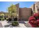 Exterior view of a well-maintained building with desert landscaping including flowering bougainvillea at 8155 E Roosevelt St # 231, Scottsdale, AZ 85257