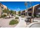 Charming courtyard featuring walkway, desert landscaping, trees, and barbecue grills at 8155 E Roosevelt St # 231, Scottsdale, AZ 85257