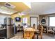 Dining area featuring a rustic wooden dining table, stainless fridge, and views of the living spaces at 8155 E Roosevelt St # 231, Scottsdale, AZ 85257