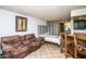 View of living room with tiled floor that transitions into a bedroom and an open kitchen with bar seating at 8155 E Roosevelt St # 231, Scottsdale, AZ 85257