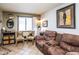 A cozy living room with comfortable seating, tile flooring, and window with natural light at 8155 E Roosevelt St # 231, Scottsdale, AZ 85257