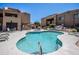 Beautiful outdoor community pool with surrounding lounge chairs, tables and desert landscaping at 8155 E Roosevelt St # 231, Scottsdale, AZ 85257