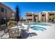 Inviting community pool and spa area with lounge chairs and table with a dark blue umbrella at 8155 E Roosevelt St # 231, Scottsdale, AZ 85257