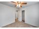 Bright bedroom featuring neutral carpet, a ceiling fan, and an adjoining closet for ample storage at 849 E Impreria St, San Tan Valley, AZ 85140