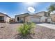 Well-kept home with desert landscaping and a covered entry, enhanced by colorful front yard plants at 849 E Impreria St, San Tan Valley, AZ 85140