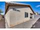Exterior view of the house with stucco siding, showing back patio and gravel landscaping at 849 E Impreria St, San Tan Valley, AZ 85140