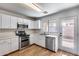 Bright kitchen featuring white cabinets, stainless steel appliances, and a view to the backyard at 849 E Impreria St, San Tan Valley, AZ 85140