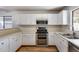 Kitchen with white cabinets, stainless steel appliances, and a double oven at 849 E Impreria St, San Tan Valley, AZ 85140