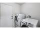 Laundry room with modern washer and dryer units, plus shelving at 849 E Impreria St, San Tan Valley, AZ 85140