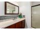 Well-lit bathroom featuring a vanity with a decorative tile backsplash and glass shower at 8500 E Southern Ave # 447, Mesa, AZ 85209