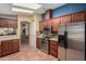 Modern kitchen with stainless steel appliances, wood cabinetry, and functional layout at 8500 E Southern Ave # 447, Mesa, AZ 85209