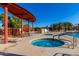 Community pool area features a jacuzzi, lounge chairs, and shade providing a resort-like experience at 8500 E Southern Ave # 447, Mesa, AZ 85209