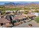 An elevated shot of a home and lush golf course, complemented by picturesque mountain views at 8541 E Canyon Estates Cir, Gold Canyon, AZ 85118