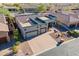 Aerial view of the exterior showcasing its three car garage and desert landscaping at 8541 E Canyon Estates Cir, Gold Canyon, AZ 85118