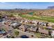 Wide aerial view of desert homes near golf course, showcasing community and landscape at 8541 E Canyon Estates Cir, Gold Canyon, AZ 85118