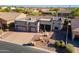 Stunning aerial view of a single-story home, showcasing the desert landscaping and brick driveway at 8541 E Canyon Estates Cir, Gold Canyon, AZ 85118
