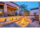 Inviting backyard featuring a modern fire pit, cushioned seating, and desert landscaping at 8541 E Canyon Estates Cir, Gold Canyon, AZ 85118