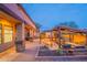 Backyard showcases a covered patio, outdoor kitchen, bar, fire pit, and desert landscape at 8541 E Canyon Estates Cir, Gold Canyon, AZ 85118