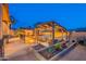 Charming outdoor kitchen and fire pit create the perfect spot for evening entertainment in this beautiful backyard at 8541 E Canyon Estates Cir, Gold Canyon, AZ 85118