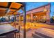 Backyard featuring a covered kitchen, bar, seating, and a cozy fire pit for outdoor entertaining at 8541 E Canyon Estates Cir, Gold Canyon, AZ 85118