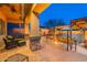 Relax in the cozy backyard oasis with a fire pit, built-in seating, and a covered patio area at 8541 E Canyon Estates Cir, Gold Canyon, AZ 85118
