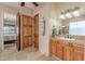 A well-appointed bathroom features a sink and decorative cabinet and is adjacent to the main bedroom at 8541 E Canyon Estates Cir, Gold Canyon, AZ 85118