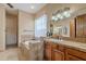 A traditional bathroom features a soaking tub with decorative tile and a vanity with a large mirror at 8541 E Canyon Estates Cir, Gold Canyon, AZ 85118
