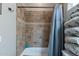 Bathroom featuring tiled shower, neatly folded towels, and shower curtain at 8541 E Canyon Estates Cir, Gold Canyon, AZ 85118