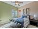 This bedroom has neutral green walls, ceiling fan, window, and wood accents at 8541 E Canyon Estates Cir, Gold Canyon, AZ 85118