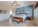 Bedroom with blue accent wall, wood furniture, and travertine flooring at 8541 E Canyon Estates Cir, Gold Canyon, AZ 85118