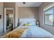 Bright bedroom with queen bed, ceiling fan, and view of the ensuite bathroom at 8541 E Canyon Estates Cir, Gold Canyon, AZ 85118