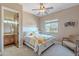 Bright bedroom with queen bed, ceiling fan, and window showcasing neighborhood views at 8541 E Canyon Estates Cir, Gold Canyon, AZ 85118