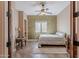 Well-lit bedroom with ceiling fan, wood-look floors, desk, and view of bed at 8541 E Canyon Estates Cir, Gold Canyon, AZ 85118