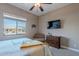 Cozy bedroom with queen bed, ceiling fan, and view of dresser, chair, and outside at 8541 E Canyon Estates Cir, Gold Canyon, AZ 85118