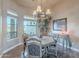 Elegant dining room with decorative chandelier, stylish furniture, and natural light from large windows at 8541 E Canyon Estates Cir, Gold Canyon, AZ 85118