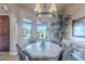 Charming dining area featuring chandelier, views to the backyard, and stylish table and chairs at 8541 E Canyon Estates Cir, Gold Canyon, AZ 85118
