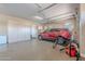 Epoxy-floored garage with lots of storage featuring an overhead door, ideal for vehicles and hobbies at 8541 E Canyon Estates Cir, Gold Canyon, AZ 85118