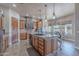 Open-concept kitchen boasts a large island, stone range hood, and breakfast nook area at 8541 E Canyon Estates Cir, Gold Canyon, AZ 85118