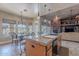 Kitchen island with granite countertops and seating overlooks the breakfast nook and living room at 8541 E Canyon Estates Cir, Gold Canyon, AZ 85118