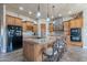 Spacious kitchen featuring an island with bar stool seating, granite countertops, and stainless-steel appliances at 8541 E Canyon Estates Cir, Gold Canyon, AZ 85118