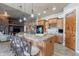 Well-equipped kitchen with central island, wood cabinetry, and breakfast bar seating at 8541 E Canyon Estates Cir, Gold Canyon, AZ 85118